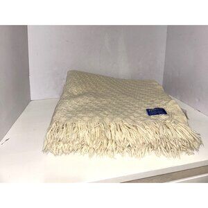 Cream-colored, fringed Pendleton throw blanket